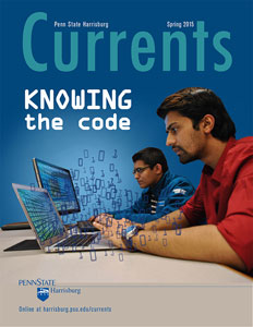 Magazine cover showing two male students writing code 