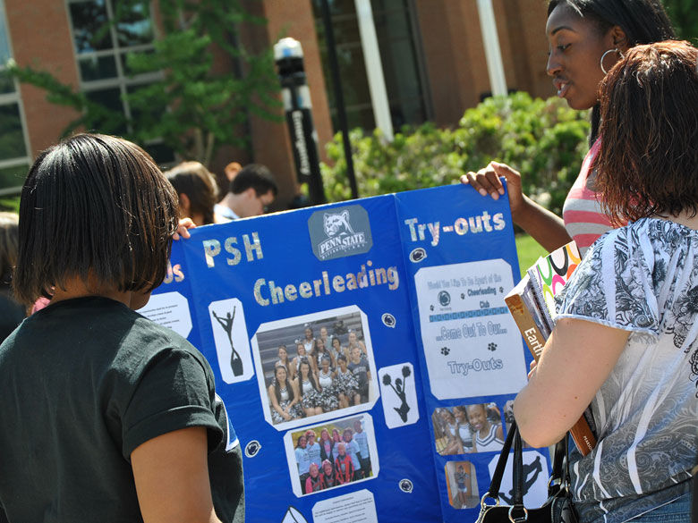 students promoting the cheerleading club at the club fair