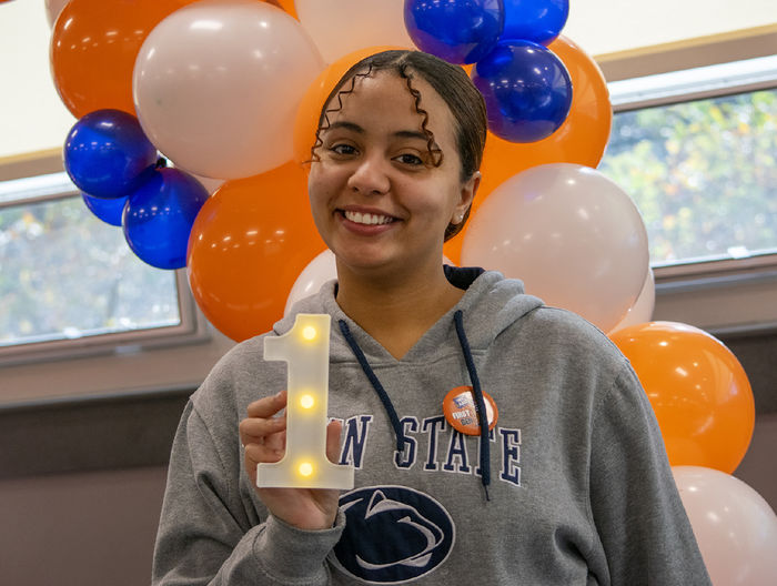 Student Raulybel Perez holds a 1 figure with lights