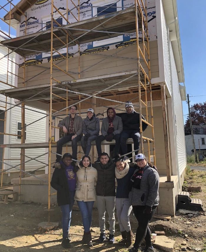 people in front of a home being built