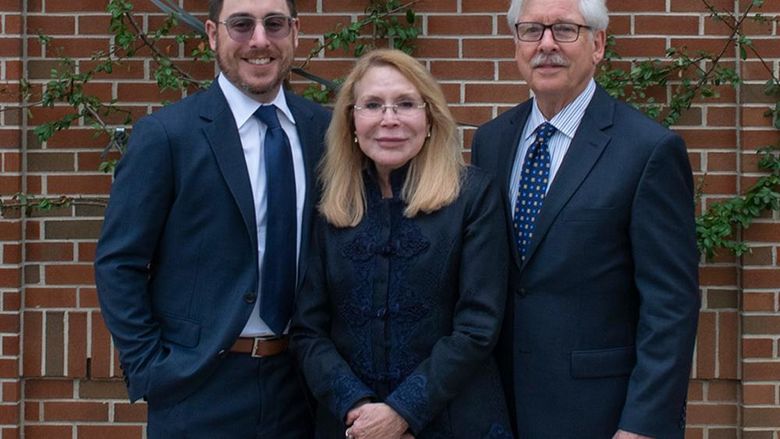 Dr. Madlyn Hanes poses with her husband and son