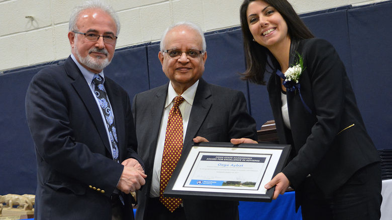 Dr. Omid Ansary and Chancellor Mukund Kulkarni congratulate Dr. Ozge Aybat on her Excellence in Advising Award