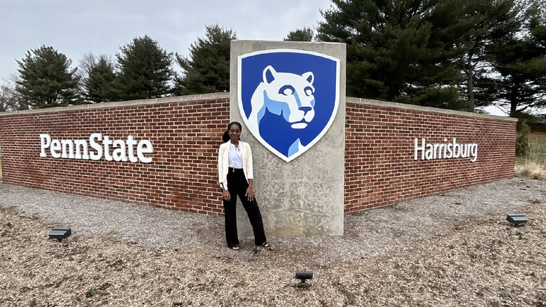 Mary Odei stands in front of the Penn State Harrisburg sign