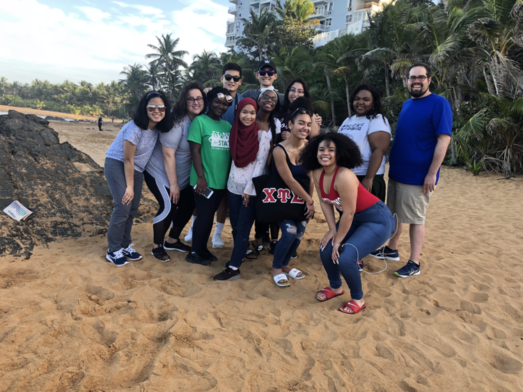 students and chaperones on the beach