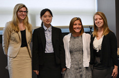 A group picture of four graduate students during a conference