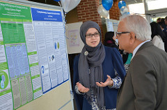 Dr. Kulkarni and a graduate student talking about her research in the poster session