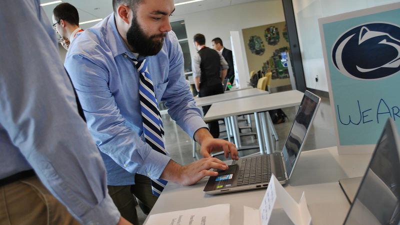 Cody Schory demonstrates software on a laptop