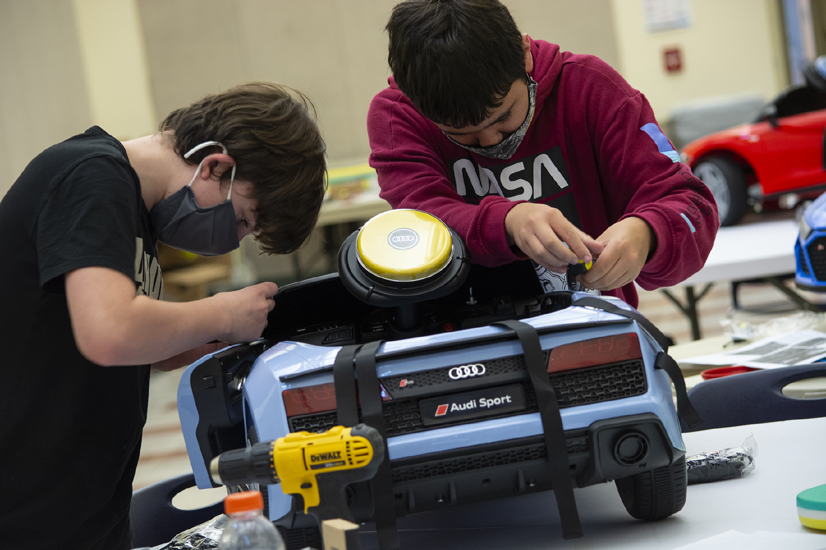 two students modifying car
