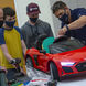 Tyler  Love and Tyler Richardson help two students modify cars