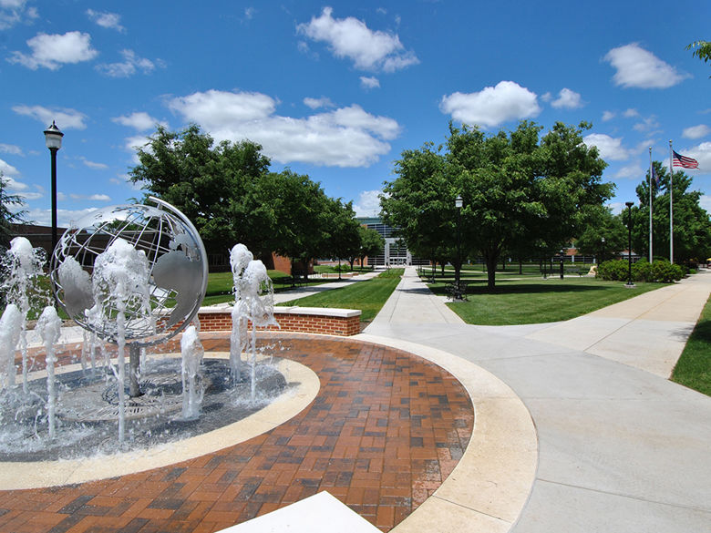 fountain with globe sculpture and campus walkways