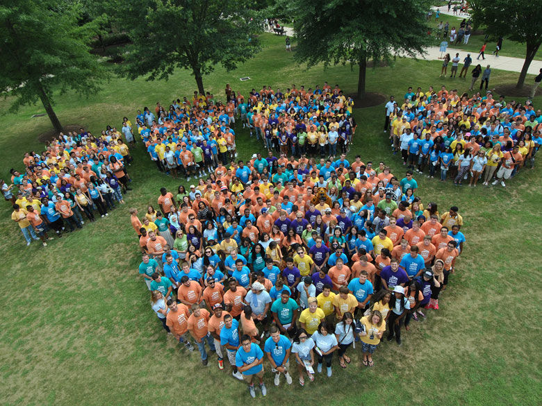 students forming a giant Penn State Paw on the quad