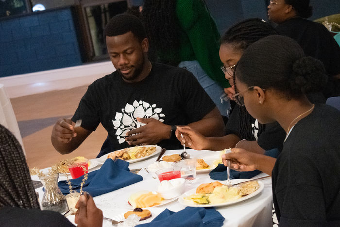 Students eat dinner during the anniversary celebration for the Multicultural Academic Excellence Program.
