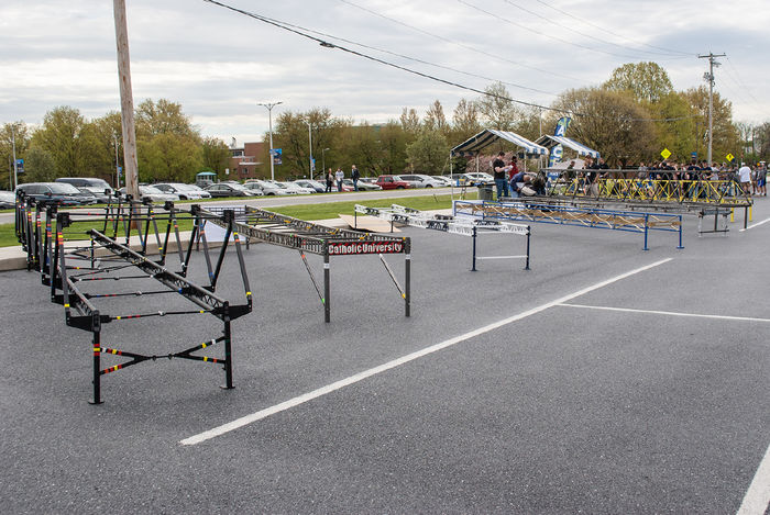 Steel bridges lined up in a  Penn State Harrisburg parking lot for a competition