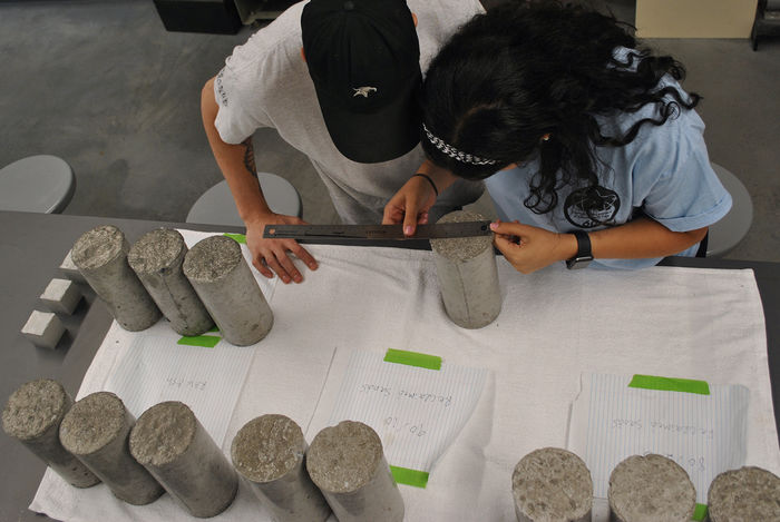 Students Kienan Dalesandro and Martina Soliman testing concrete samples