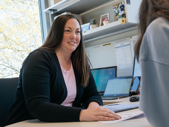 Jody Salsman works with a student in her office