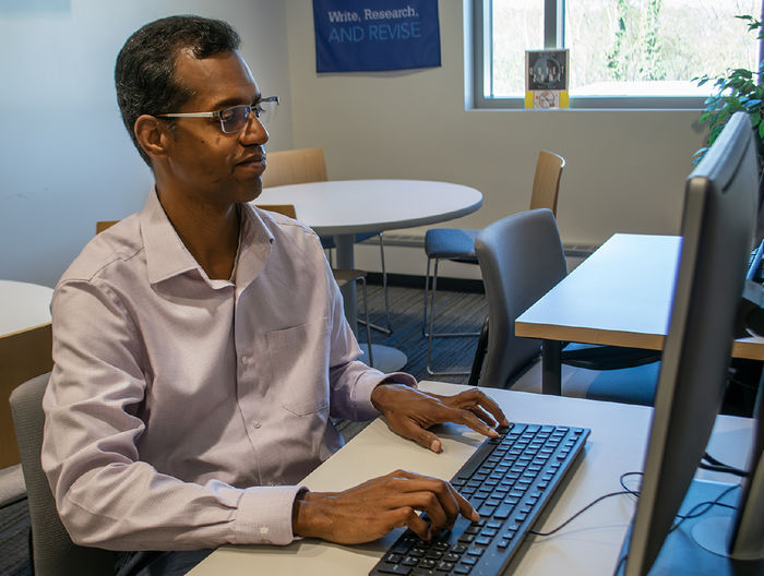 a professor working at a computer