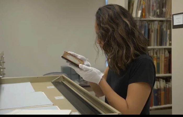 American Studies student examining a text in the archives