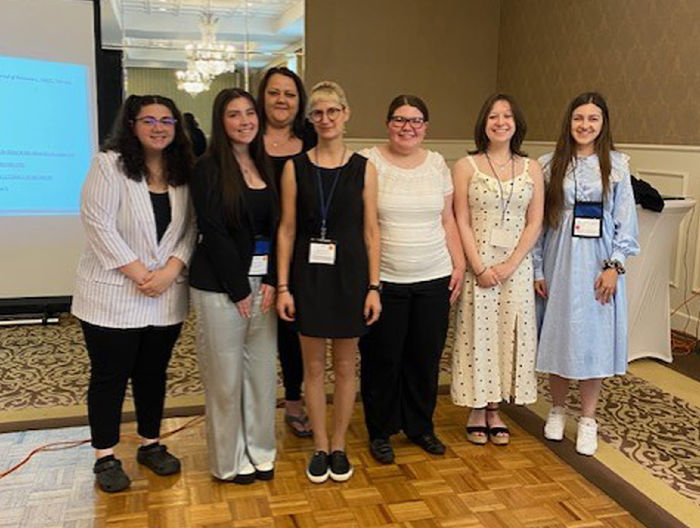 Group photo of seven women at the Northeastern Association of Criminal Justice Sciences conference