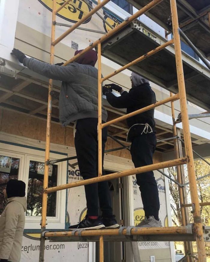 students standing on scaffolding