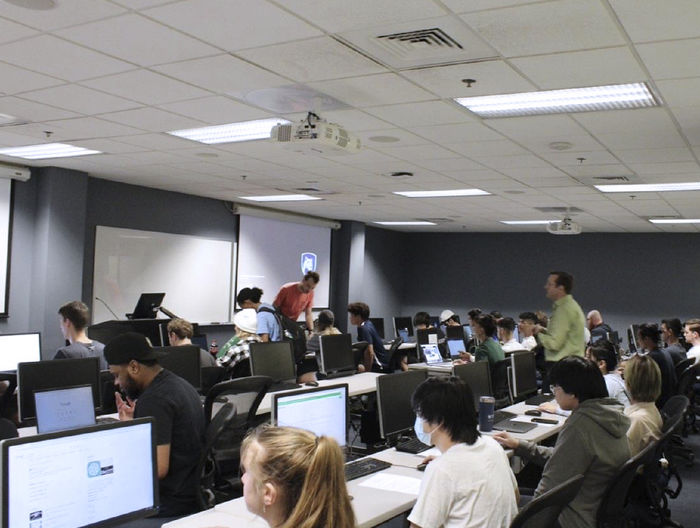 Rows of students fill a computer lab during a programming competition