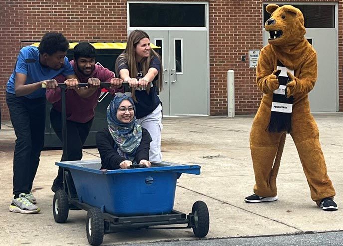 The Nittany Lion cheers the Career Studies team as they prepare to run the campus' annual Bathtub Race.