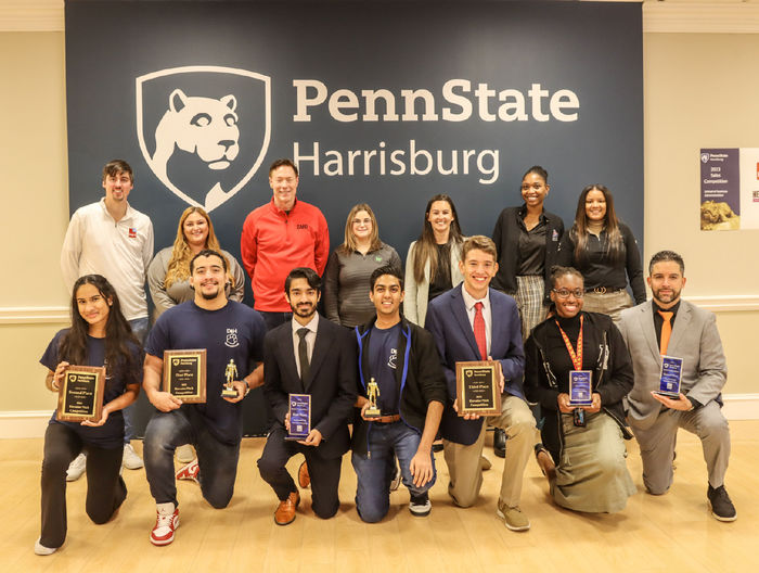 Group photo of students holding awards