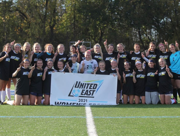 Kylee Altland and the Penn State Harrisburg women's soccer team holding the United East banner