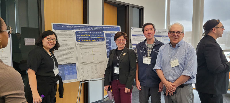 CSUA conference attendees pose during the poster session.