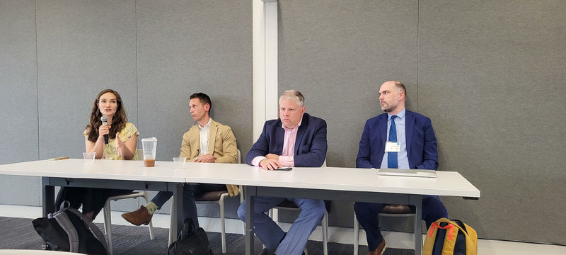 Four people sit at a panel in the Eric J. Barron Innovation Hub.