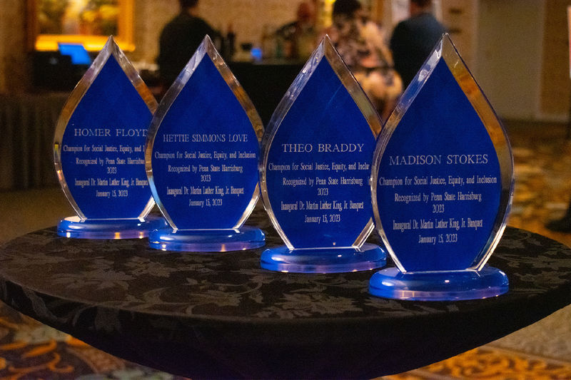 four teardrop shaped crystal award trophies