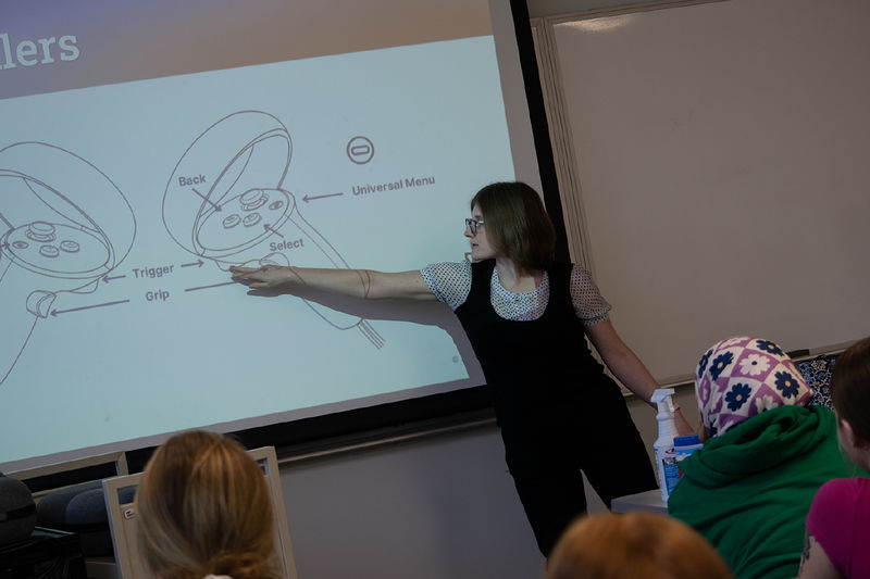 Sarah Kettell, programmer/analyst with the Center for Teaching Excellence at Penn State Harrisburg, points at a screen showing a diagram of virtual reality controllers.