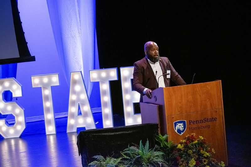 Gibran Jones speaks onstage at the Penn State Harrisburg Alumni Awards ceremony
