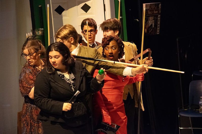 Six characters huddle together in a scene from Penn State Harrisburg's production of "Clue"