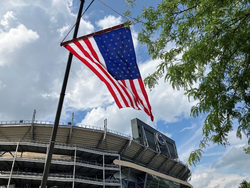 An American flag flies in front of Beaver Stadium