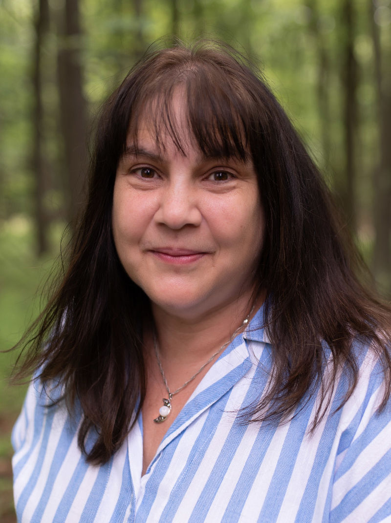 photo portrait of woman in woods wearing striped blouse