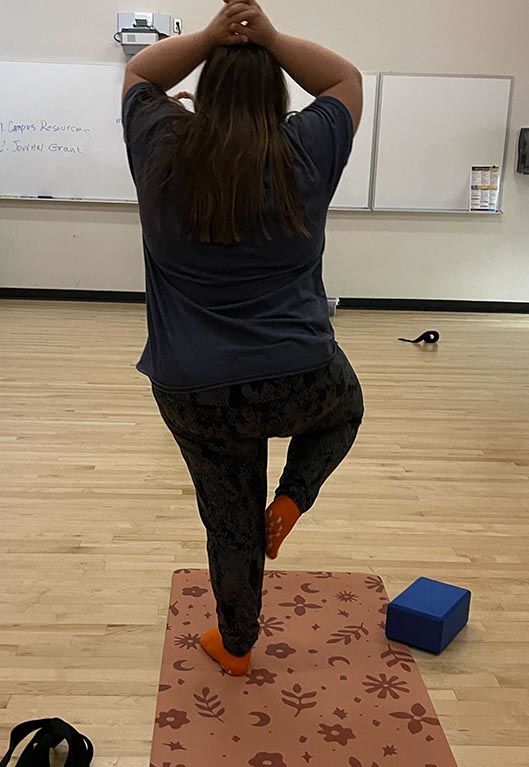 Sarah practicing Yoga during her academic class