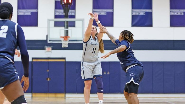Kendis Butler, a Penn State Harrisburg women's basketball player, shoots a 3-pointer during a game