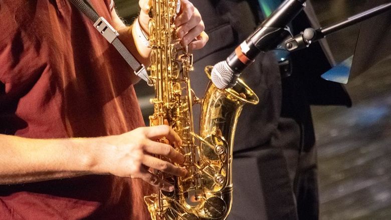 Closeup of a person playing a saxophone