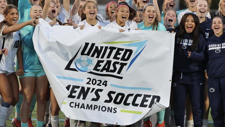 Penn State Harrisburg women's soccer team holding a banner that says United East 2024 Women's Soccer Champions