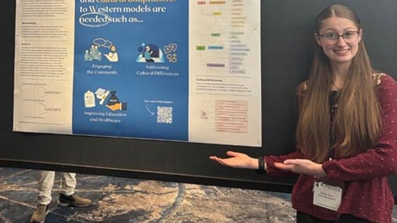 Kaitlyn Arrow with her presentation poster