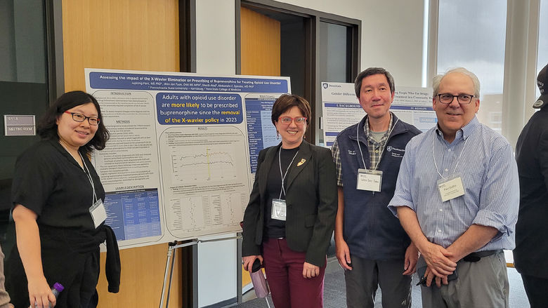 CSUA conference attendees pose during the poster session.