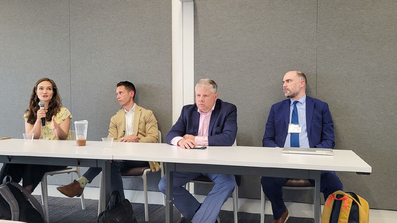 Four people sit at a panel in the Eric J. Barron Innovation Hub.