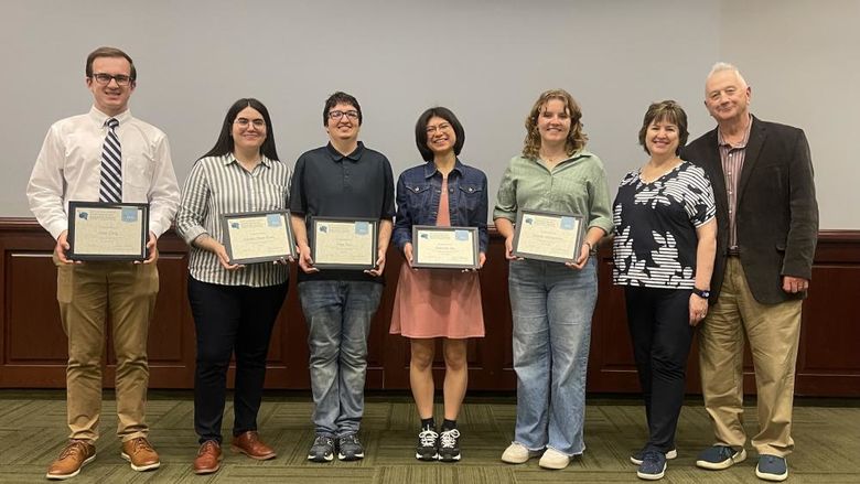 5 students holding awards standing next to John Sr. and Kimlyn Patishnock 