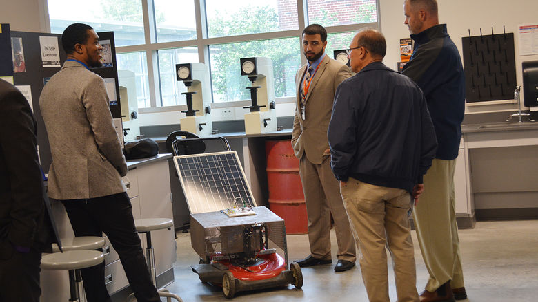 Students demonstrate a solar-powered lawn mower