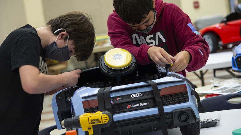 two students modifying car