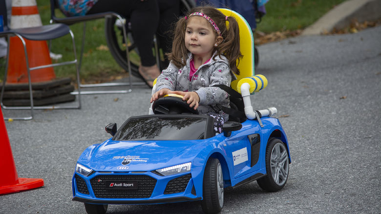 child testing toy car