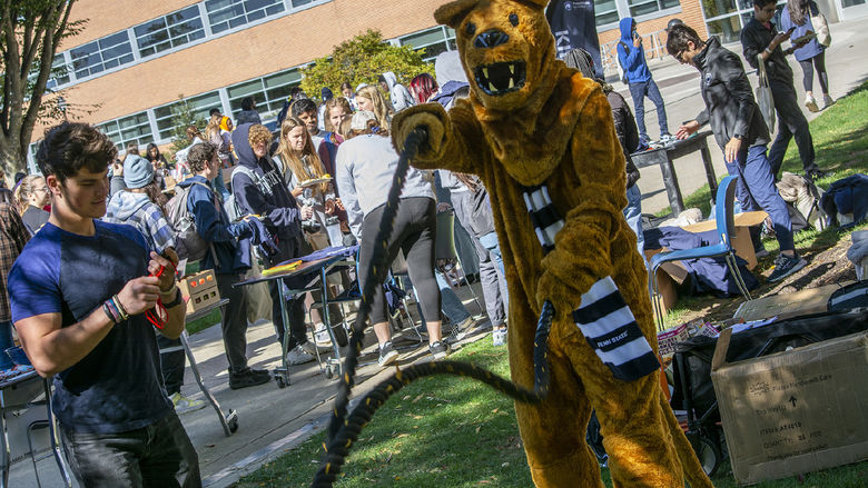 Nittany Lion uses ropes at a fitness station during Exercise is Medicine in 2022