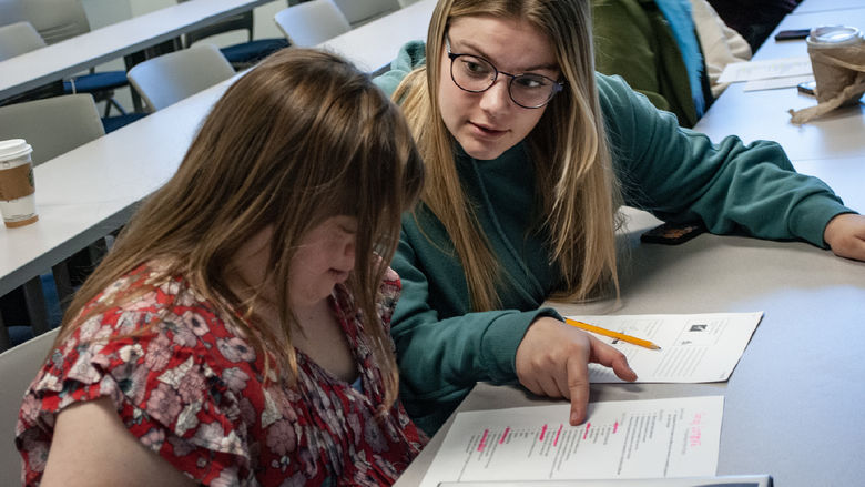 Students look at an assignment during class.