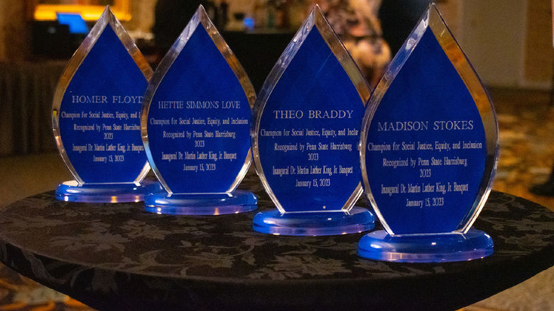 four teardrop shaped crystal award trophies