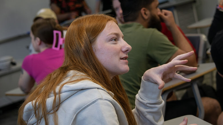 A student talks with a group about using virtual reality headsets